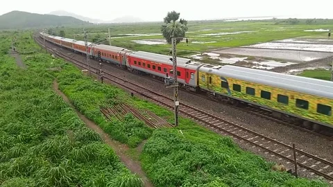 Indian Railways Rajdhani Express Train speed countryside Aerial Vaitarna India Stock Footage 141564235