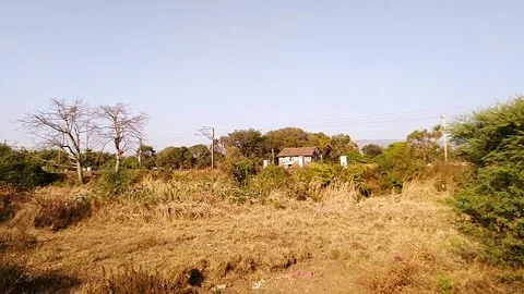 Indian Railways yellow express train speeding crossing railway station Kelve rd Stock Footage 127011270