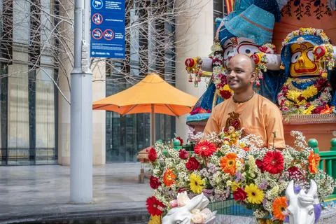 An Indian religious Hare Krishna devotee sitting on a float Stock Photos