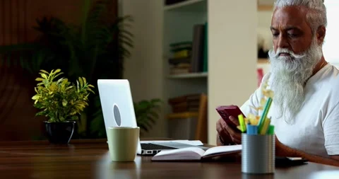 Indian Reviewing share market data at breakfast, asian mid age man trading Stock Footage 342778875