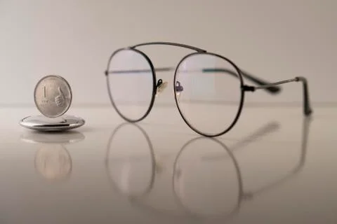 Indian rupee and spectacles Stock Photos