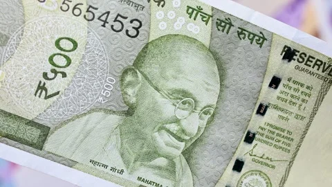 Indian rupee banknote falling on Chinese Yuan banknotes background. Stock Footage 309877552