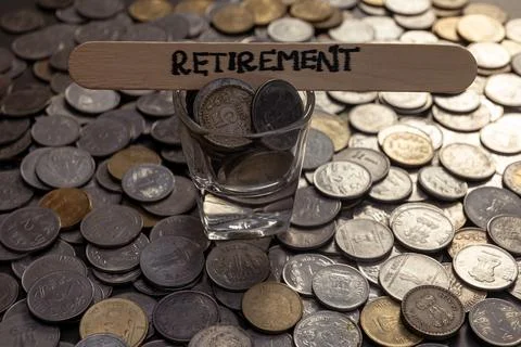 Indian Rupees Coins Spread on Table with Retirement Word Stock Photos