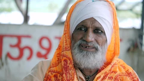 Indian saint sitting outside a temple Stock Footage 163874698