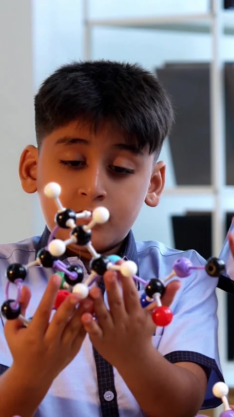 Indian School Kids Studying Atom Model Using 3D Tool in Classroom Science Video stock 342844231