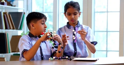 Indian School Kids Studying Atom Model Using 3D Tool in Classroom Science Stock Footage 342849893