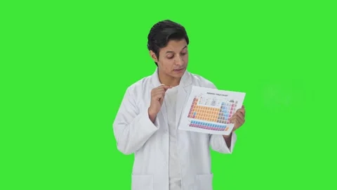 Indian scientist explaining periodic table Green screen Stock Footage 253558543