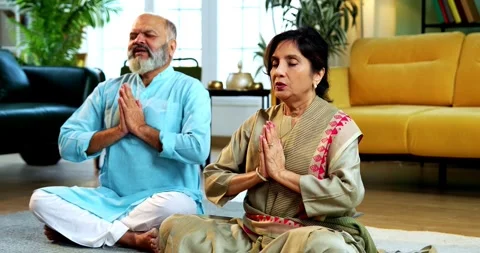 Indian senior couple doing pranayama or yoga at home in the morning Video stock 342787938