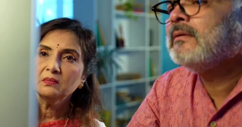 Indian senior couple using computer at home for work, accounting Stock Footage 343111686