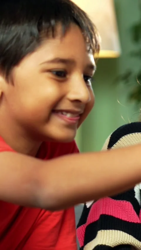 Indian siblings exploring creativity by painting on a canvas at home Stock Footage 343214427