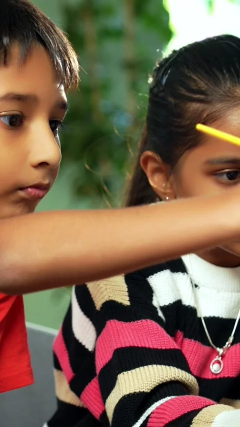 Indian siblings exploring creativity by painting on a canvas at home Stock Footage 343214432