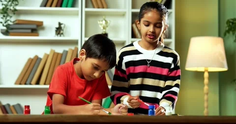 Indian siblings exploring creativity by painting on a drawing paper at home Video stock 343215889