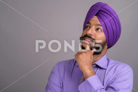 Indian Sikh businessman wearing turban while thinking Stock Photos