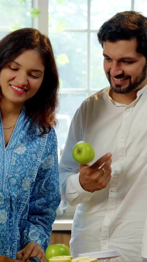 Indian smart young couple making healthy juice in kitchen Stock Footage 343415909