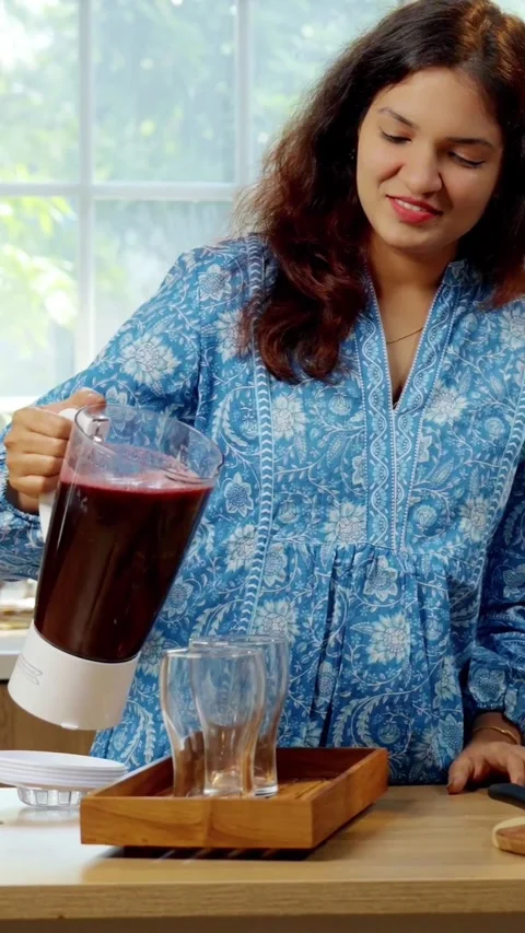 Indian smart young couple making healthy juice in kitchen Stock Footage 343416216