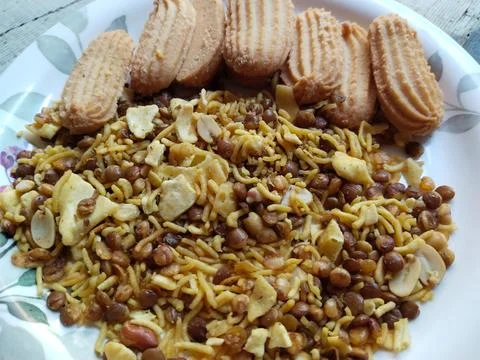 Indian snack: Mixture, Biscuit and Spicy Namkeen in plate for guests Stock Photos