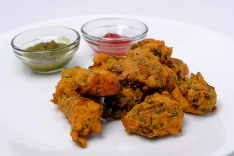 Indian snack pakora with tomato sauce or chutney Stock Photos