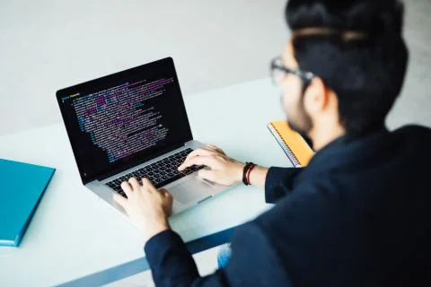 Indian software developer busy with work on new project. Indian programer wor Stock Photos