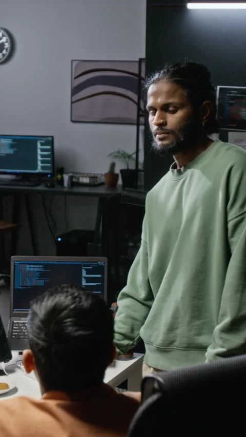 Indian Software Developer Discussing Code with Colleague in Office Stockbeeldmateriaal 348347119