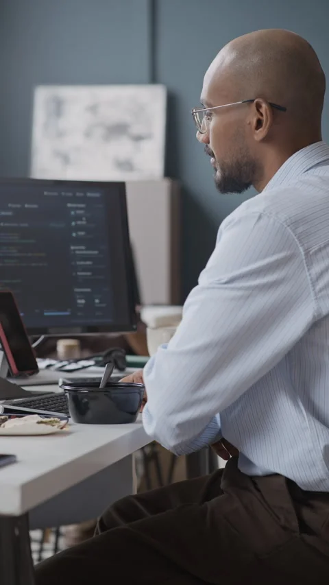Indian Software Developer Eating Lunch during Coding on Computer Stock Footage 337476124