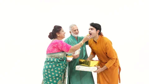 Indian son giving gift to his parent's,touching feet during diwali. Stock Footage 253269874