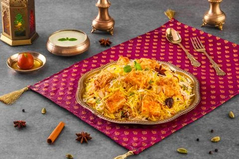 Indian spisy food Paneer Tikka biryani with raita and gulab jamun Served in a Stock Photos