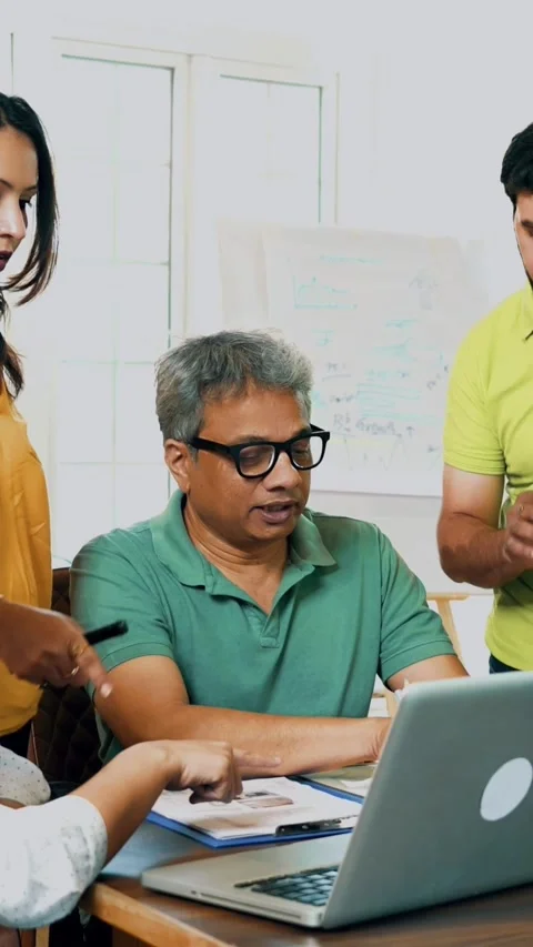 Indian startup team discussing project strategy with a laptop and documents Stock-Footage 342507924