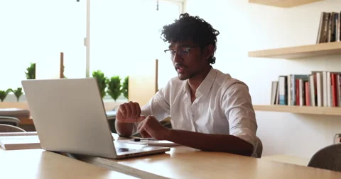 Indian student guy in glasses talking on video conference chat Video stock 287018449