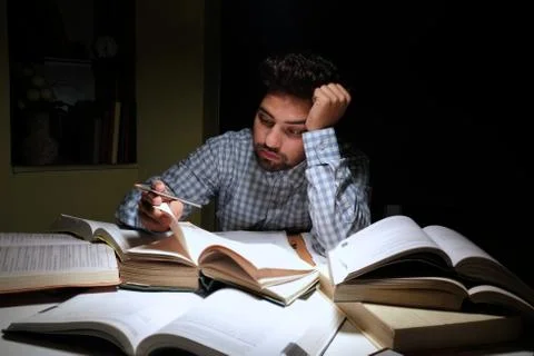 Indian student overloaded with work. Stock Photos