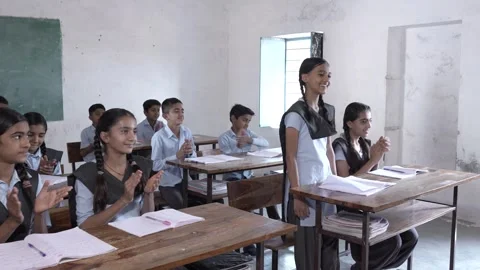 Indian students clapping for intelligent schoolboy at classroom, Children g.. Stock Footage 273549930