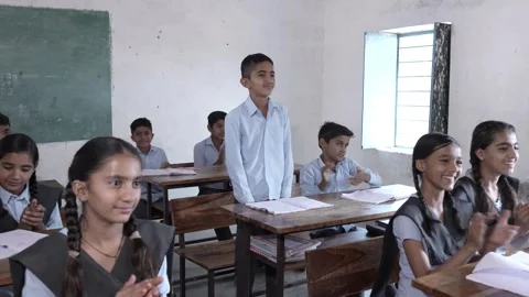 Indian students clapping for intelligent schoolboy at classroom, Children g.. Stock Footage 273550154