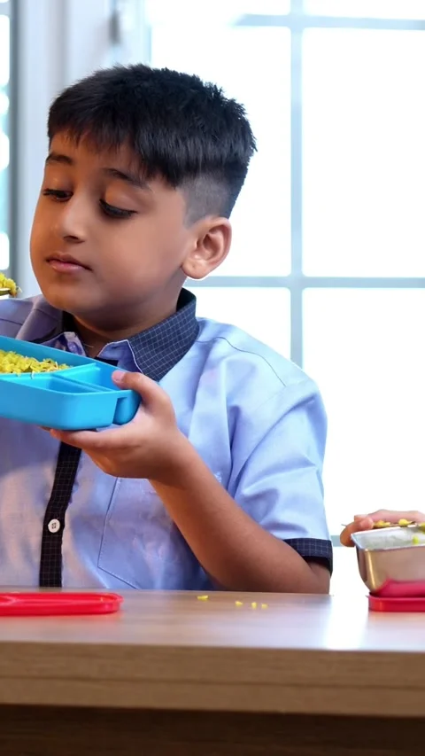 Indian students enjoy lunch break, sharing tiffin laughter in classroom Stock Footage 342844200