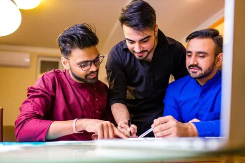 Indian students learning foreign language together at home in living room by Stock Photos