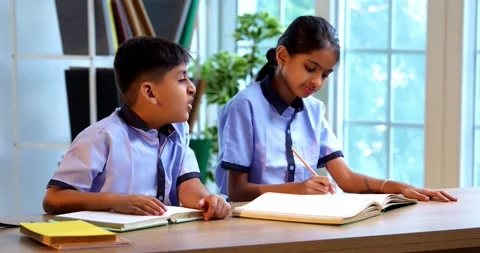Indian Students in school uniforms raise hands to answer teacher’s question Stock Footage 342850630