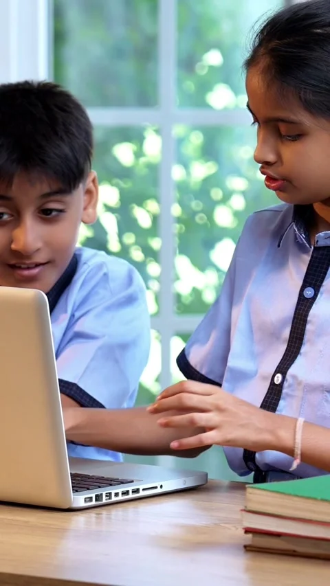 Indian Students in school uniforms study together on laptop in classroom Stock Footage 342844285