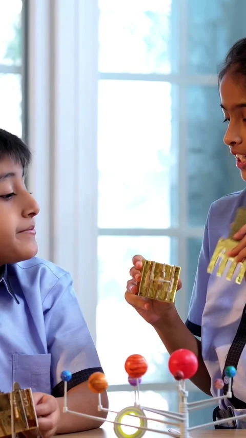 Indian students in uniform explore satellite model in classroom lesson on space Stock Footage 342844174
