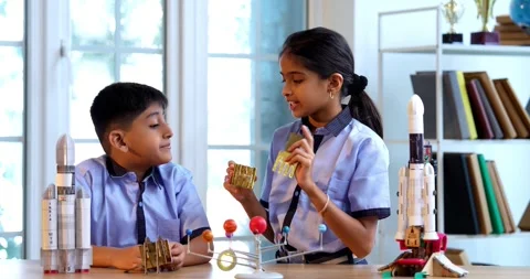 Indian students in uniform explore satellite model in classroom lesson on space Stock Footage 342849286