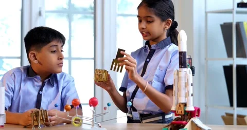 Indian students in uniform explore satellite model in classroom lesson on space Stock Footage 342849404