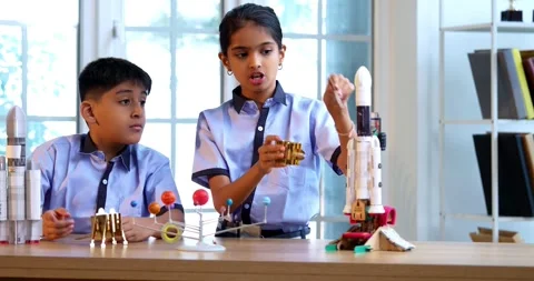 Indian students in uniform explore satellite model in classroom lesson on space Stock Footage 342849413