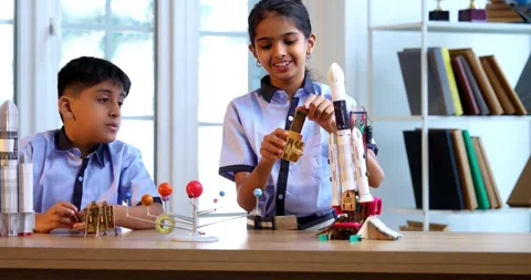 Indian students in uniform explore satellite model in classroom lesson on space Stock Footage 342849425