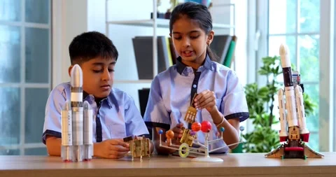 Indian students in uniform explore satellite model in classroom lesson on space Stock Footage 342849429
