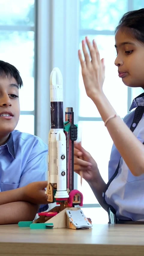 Indian students in uniform test 3D rocket model in classroom Stock Footage 342844162