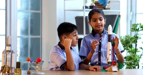 Indian students in uniform test 3D rocket model in classroom Stock Footage 342849241