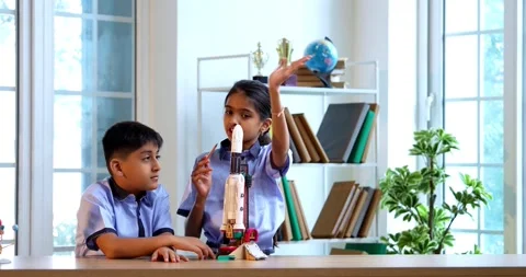 Indian students in uniform test 3D rocket model in classroom Stock Footage 342849284