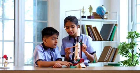 Indian students in uniform test 3D rocket model in classroom 스톡 동영상 342849293