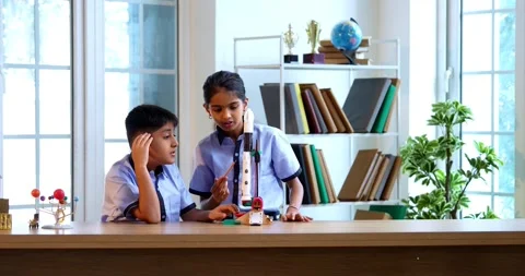 Indian students in uniform test 3D rocket model in classroom 스톡 동영상 342849300