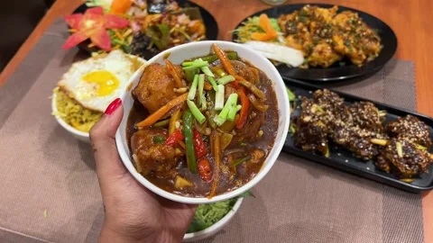 Indian style chilli chicken served with other chinese dish in Kolkata Stock Footage 315129355