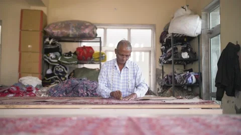 Indian tailor marks the cutting edges on handmade Rajasthani cloth. Stock Footage 151905295