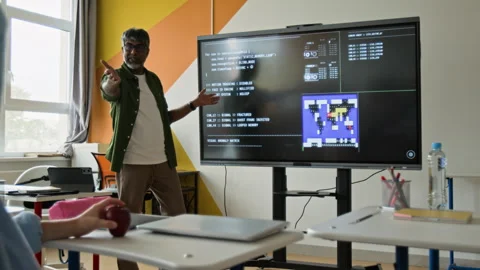 Indian Teacher Explaining Coding to Teenage Boy in Classroom Stock Footage 342818229