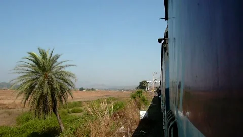 Indian Train Arriving at scenic Remote Vaitarna Railway station Mumbai India Video stock 139670375